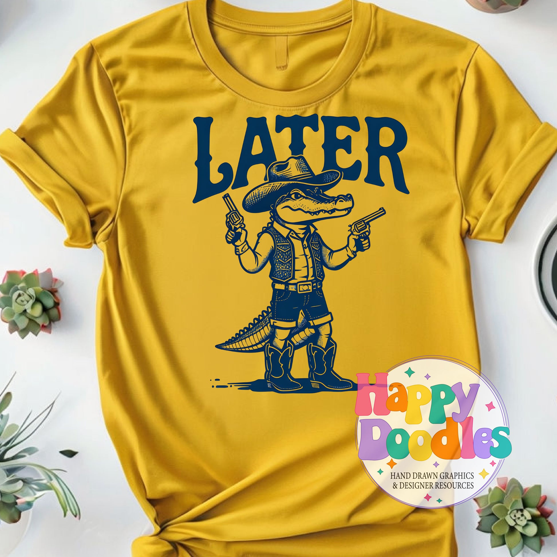 Yellow t-shirt with a graphic of a crocodile in cowboy attire holding guns and the word 'LATER' on a white background.